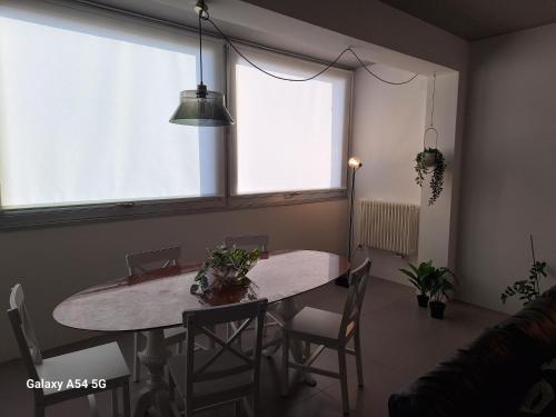 a dining room with a table and chairs and a window at Perla delle Egadi in Marsala