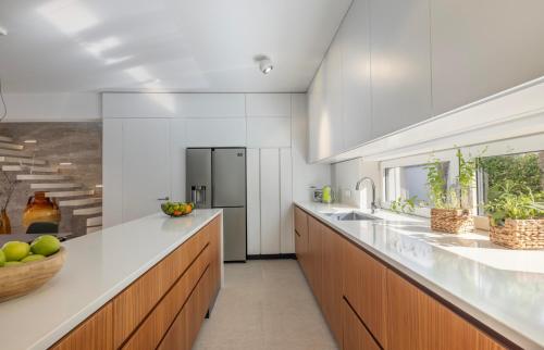 a kitchen with white counters and wooden cabinets at Villa Amorosa in Nerezine
