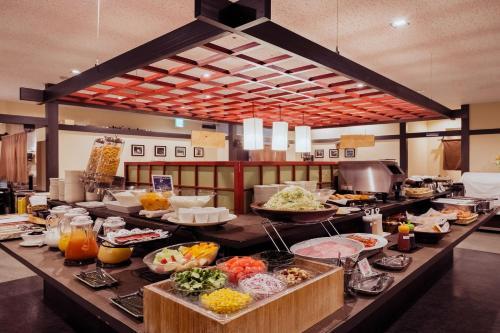 a buffet line with many different types of food at HOTEL MYSTAYS PREMIER Kanazawa in Kanazawa