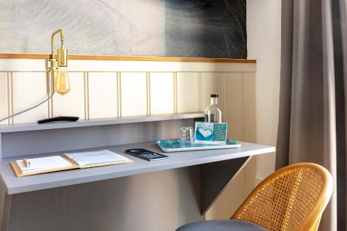 a room with a shelf with a bottle and a chair at Hotel Bethanien in Langeoog