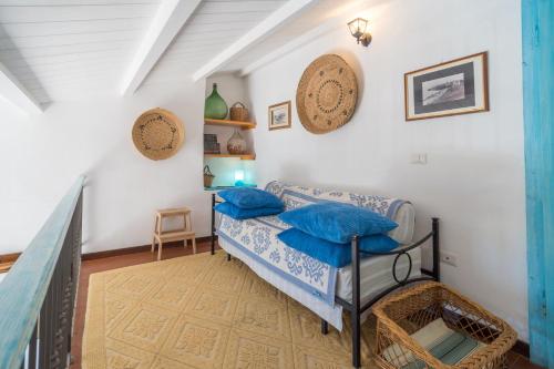 a room with a bed with blue pillows on it at Alghero Bastioni colombo sea view in Alghero