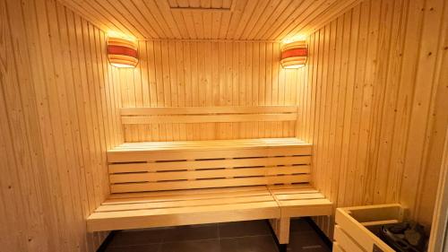 a wooden sauna with two lights on top of it at Kyriad Prestige Compiègne Hotel & Spa in Compiègne