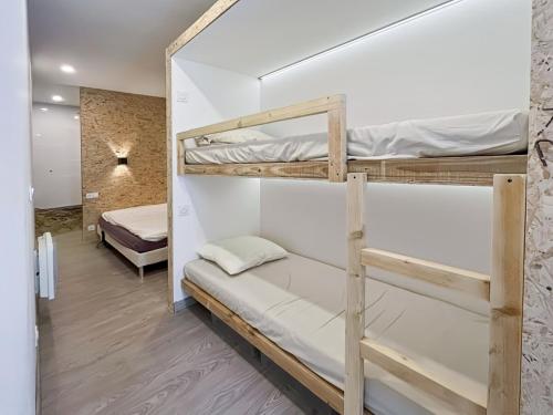 a room with two bunk beds in a room at Maison FLOËGE in Burzet
