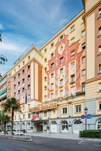 a large hotel with a sign on the front of it at Sercotel Gran Hotel Conde Duque in Madrid