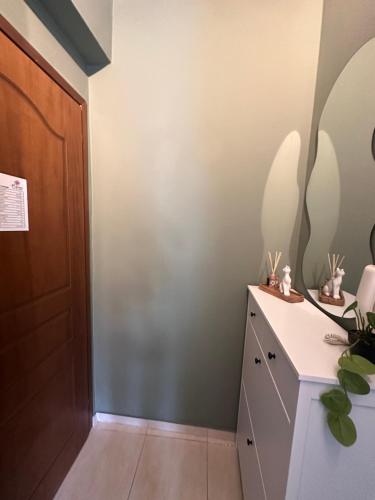 a hallway with a dresser and a door at Bloem in Komotini
