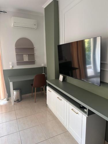 a living room with a large flat screen tv at Bloem in Komotini