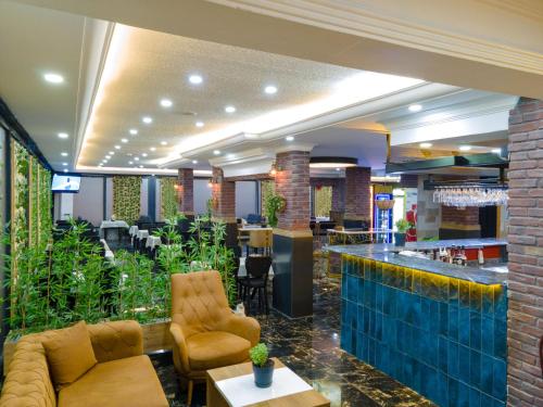 a lobby of a hotel with a bar and chairs at Bianco Beach Hotel in Kusadası