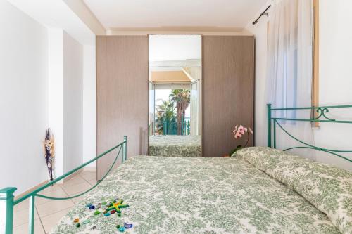 a bedroom with a bed and a mirror at I Ciottoli Dello Ionio in Mascali
