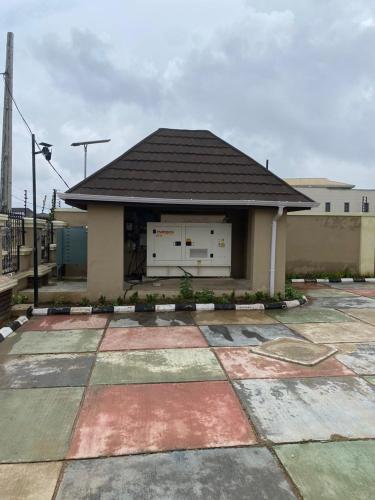 a building with a garage with a roof at Folulakes Regal Villas in Ibadan