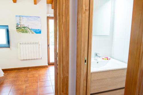 a bathroom with a sink and a tub at Casa Pedroso in Noja