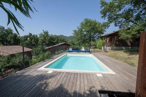 - une piscine sur la terrasse d'une maison dans l'établissement Chalet Orange - Piscine Partagée, à Darbres