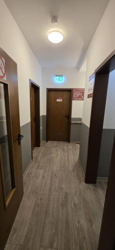 a hallway of an office with doors and wooden floors at My Pension 01 in Leinfelden-Echterdingen