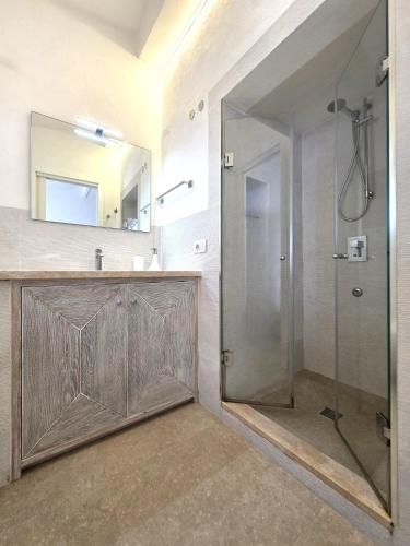 a bathroom with a shower with a glass door at Blue Eden La Maddalena in La Maddalena