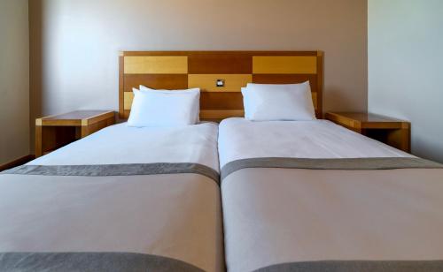 two beds in a hotel room with two beds at Grand Hotel Blackpool in Blackpool