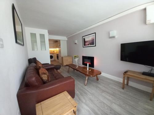 a living room with a couch and a flat screen tv at Newcastle Court in Galway