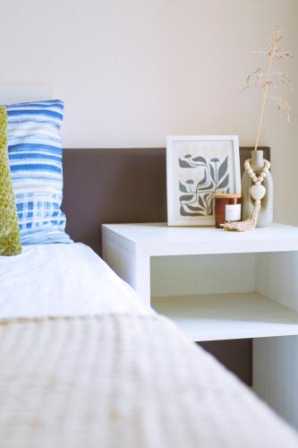 a bedroom with a white bed and a side table at Casa Vacanze - Le Dimore Del Borgo Antico in Campomarino