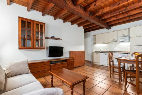 a living room with a couch and a table at Apartamentos El Rincón de Bustio in Bustio