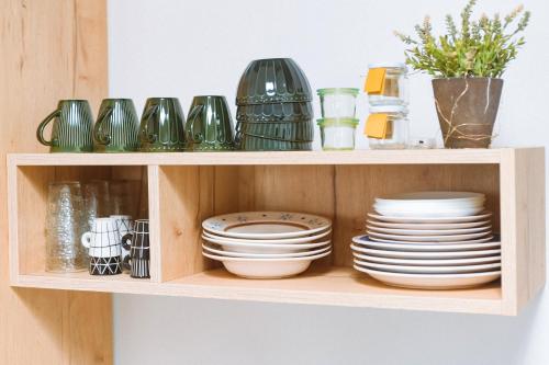 a wooden shelf with plates and dishes on it at Casa Vacanze - Le Dimore Del Borgo Antico in Campomarino