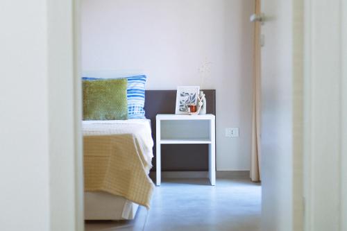 a bedroom with a bed and a side table at Casa Vacanze - Le Dimore Del Borgo Antico in Campomarino