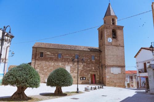 a large brick building with a clock tower at Casa Vacanze - Le Dimore Del Borgo Antico in Campomarino