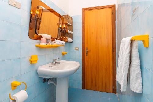 a bathroom with a sink and a mirror at I Ciottoli Dello Ionio in Mascali