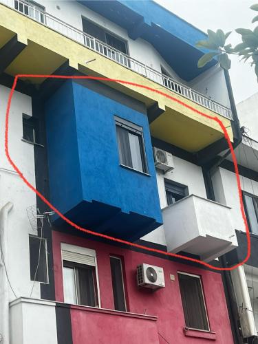 a building with a blue and red at Dyrrah G In the heart of Durres in Durrës
