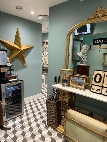 a room with a mirror and a checkered floor at Rooms at number one in Broadstairs