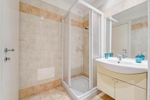 a bathroom with a sink and a shower at Green Village Accommodations in Colico