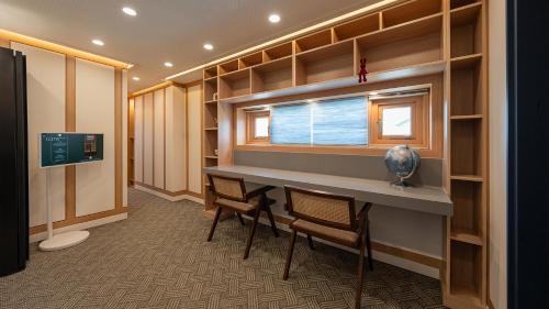 a room with a table and chairs and a window at Hwangridan Stay in Gyeongju