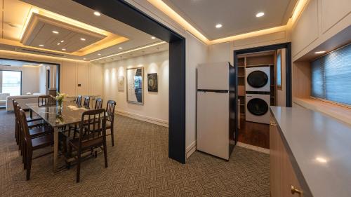 a kitchen and dining room with a table and a refrigerator at Hwangridan Stay in Gyeongju