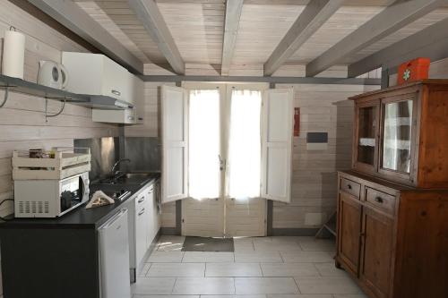a kitchen with white appliances and a window in it at Podere Badia Valdrago Agriturismo Mugello Circuit in Scarperia
