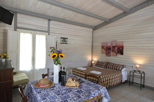 a bedroom with a bed and a table and a bed and a table with flowers at Podere Badia Valdrago Agriturismo Mugello Circuit in Scarperia
