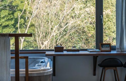 a bathroom with a sink and a large window at Meijie Xiuju in Xinchating