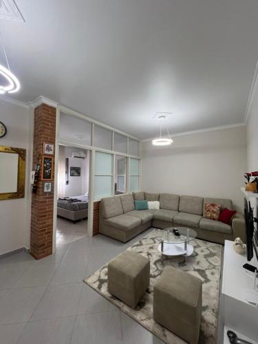 a living room with a couch and a table at Guest House Orest in Vlorë