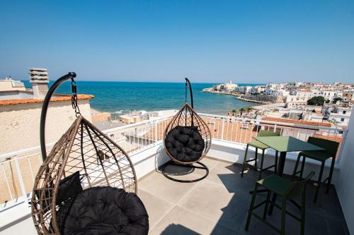 a balcony with a view of the ocean at my Vesta Suites in Vieste