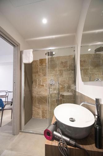 a bathroom with a sink and a shower at my Vesta Suites in Vieste