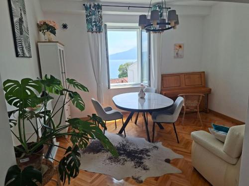 un salon avec une table et une plante dans l'établissement Boka view Heritage Apartment, à Herceg-Novi