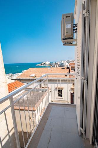 a balcony with a view of the ocean at my Vesta Suites in Vieste