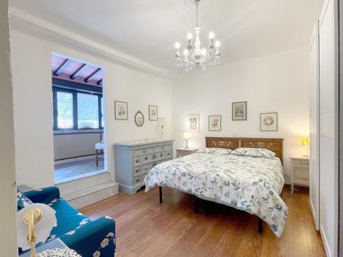 a bedroom with a bed and a chandelier at La Loggia near Piazza del Campo in Siena