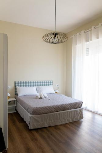 a bedroom with a bed and a large window at Sahil Apartment in Giulianova