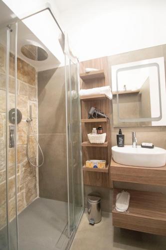 a bathroom with a shower and a sink at my Vesta Suites in Vieste