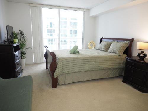 a bedroom with a bed and a large window at Emerald2 Room at Brighton Beach 2Min Walk to Ocean & Subway Chic Stay in Brooklyn