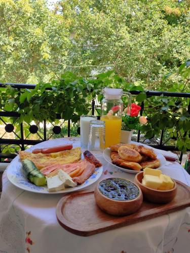 a table with plates of cheese and other food on it at Kashah Residence in Gjirokastër