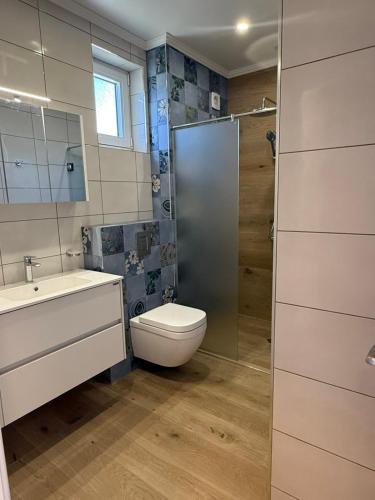 a bathroom with a toilet and a sink and a shower at Aurum Villas Smokinya Beach in Sozopol