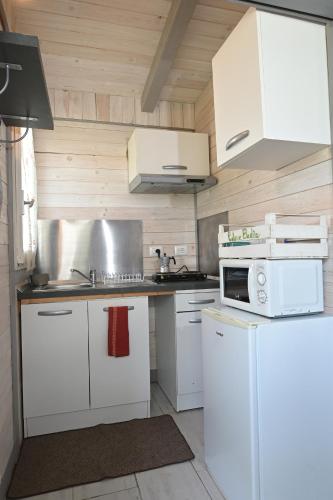 a kitchen with white cabinets and a stove top oven at Podere Badia Valdrago Agriturismo Mugello Circuit in Scarperia
