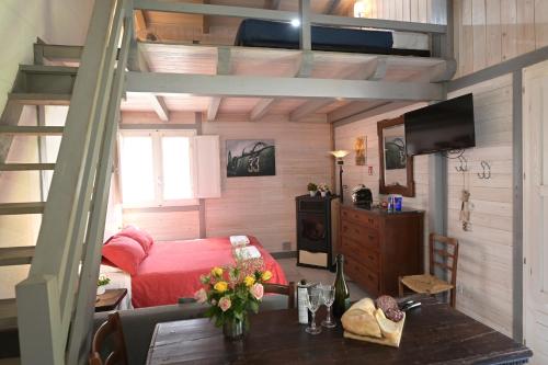 a bedroom with a bunk bed and a table with flowers at Podere Badia Valdrago Agriturismo Mugello Circuit in Scarperia