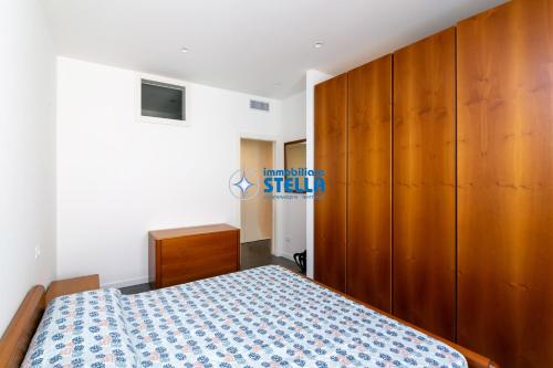 a bedroom with a bed and a wooden cabinet at Vittoria Palace in Gallarate