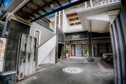 an entrance to a building with a bike sign on the ground at Denays Guest House Jimbaran in Ngurah Rai International Airport