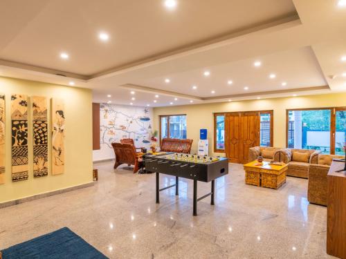 a living room with a pool table in the middle at Hotel Bayshu - The Hosteller Leh in Leh