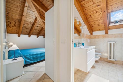 a bathroom with a blue bed in a room at Green Village Accommodations in Colico